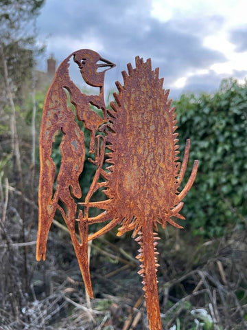 Image of a Goldfinch on Teasel, laser cut from metal and rusting in colour.