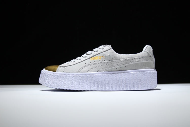 white pumas with gold toe