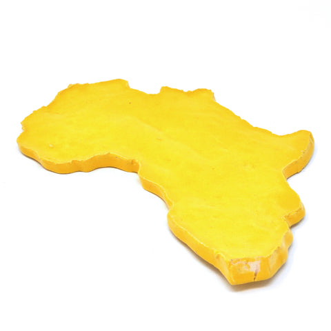 a ceramic sculpture in the shape of the continent of Africa, in a vivid yellow color.