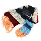 A knitted scarf with stripes of various colors and long peach-colored tassels.