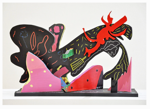 a wooden sculpture painting in pink, black and red paint marker.