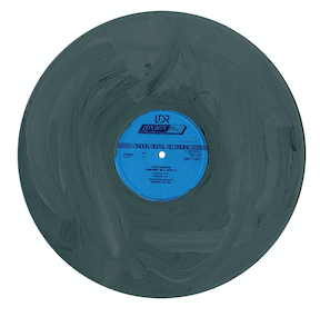 a music record that has been painted on with grey paint. the blue label is still visible in the center of the object. the curator expands on description of this object in the text directly below.