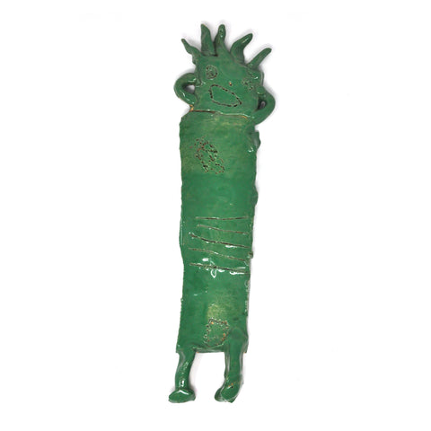 a ceramic sculpture of a figure with spiky hair, glazed green