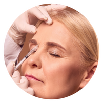 60+ woman getting a wrinkle injection between her eyebrows