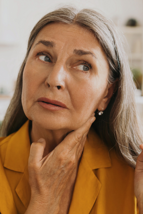 Aging 60 year old caucasian woman with shoulder length silver hair and jowls
