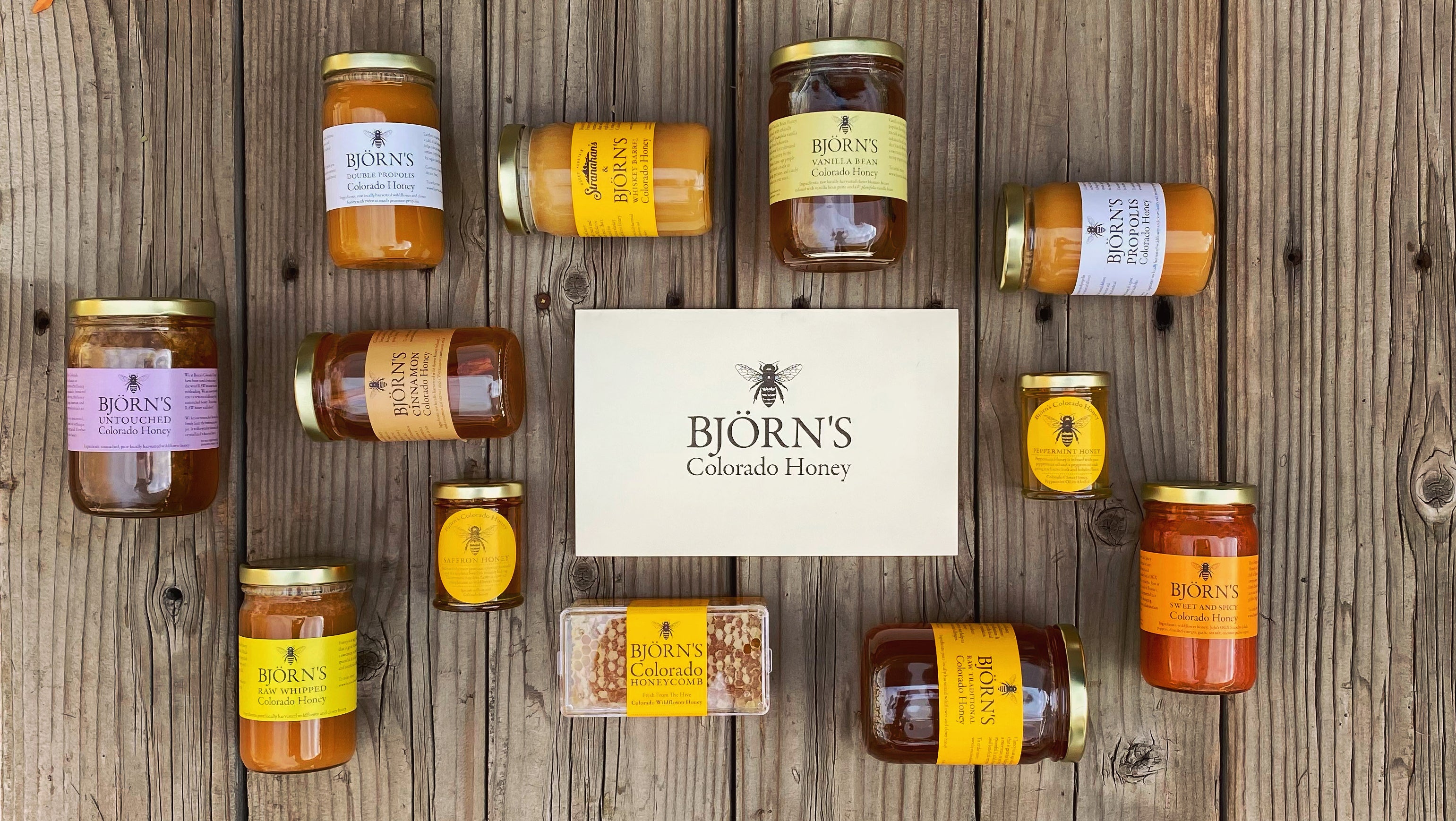 photo of multiple honey jars with a printed holiday card in the center
