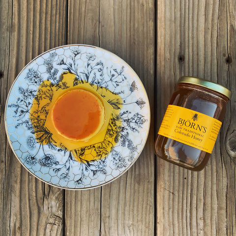 Honey Creme Caramel on a patterned plate with a jar of Bjorn's Raw Traditional Honey next to it