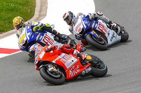 Rossi celebrating his 100th race victory at the 2009 Dutch TT and battling with Casey Stoner and Jorge Lorenzo at the 2009 German Grand Prix