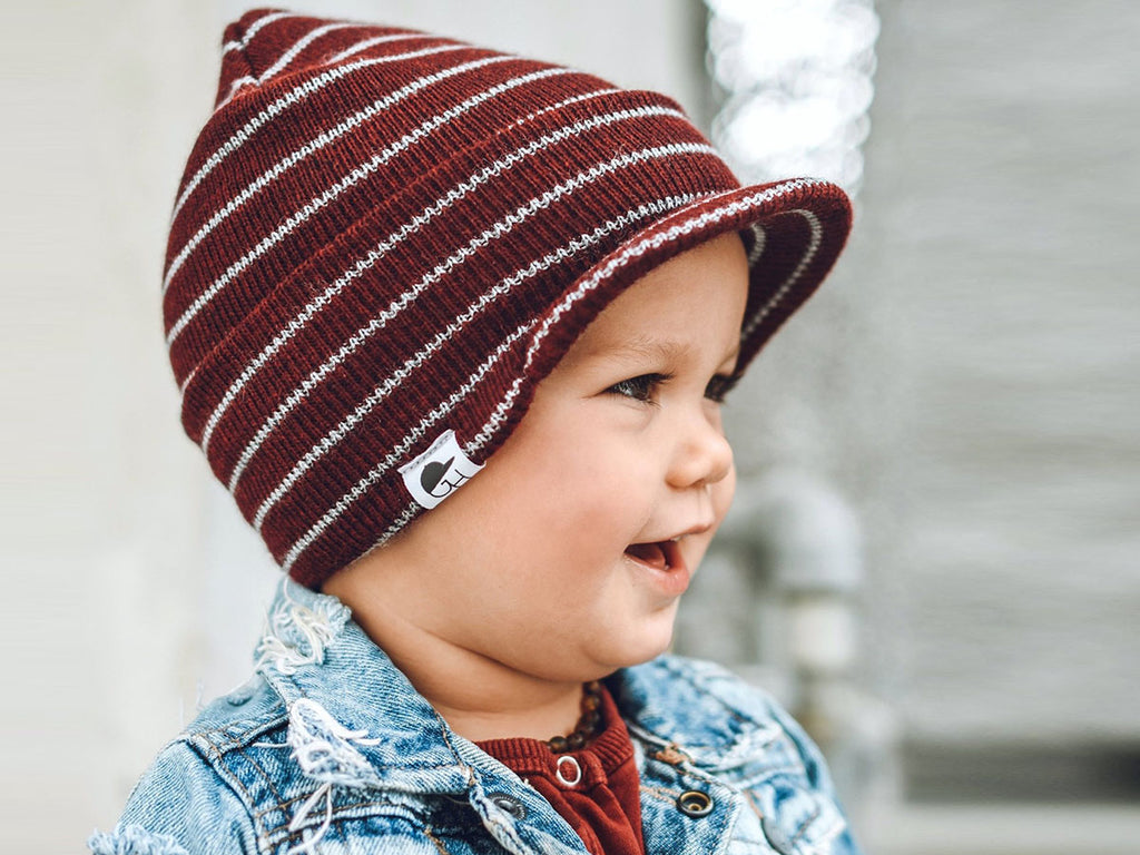 toddler in a burgundy striped winter beanie