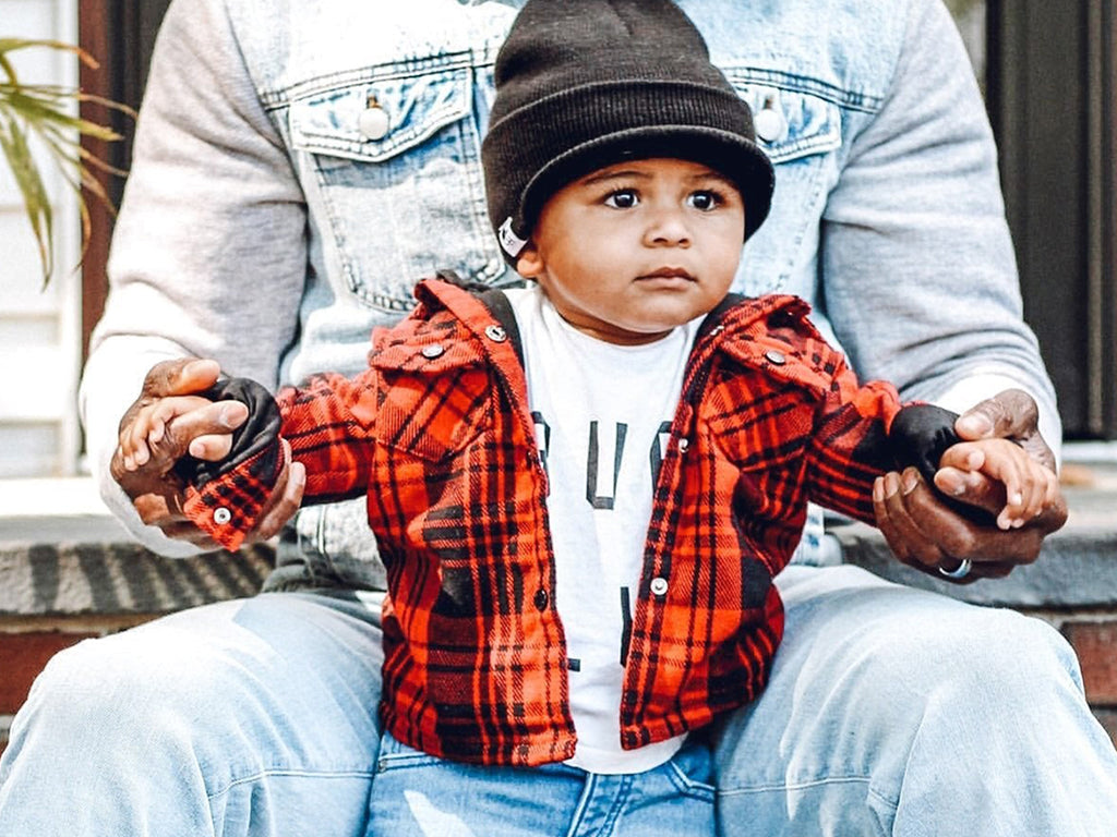 Child wearing our Black Marled Pom Beanie