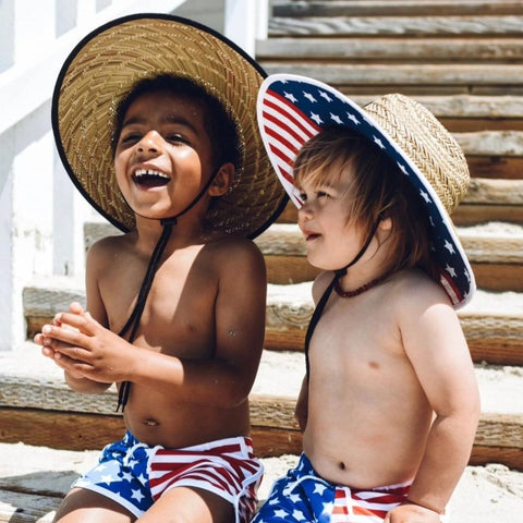 photo of 2 young boys wearing straw hats