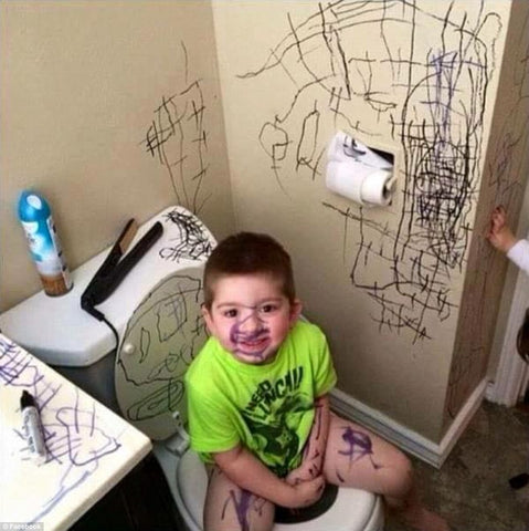 kid on potty marker on wall