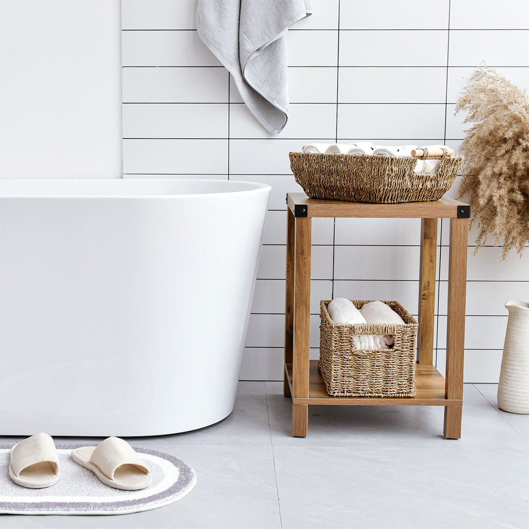 Handwoven Seagrass Large Storage Baskets with Wooden Handles on a side table beside a bathtub in the bathroom.
