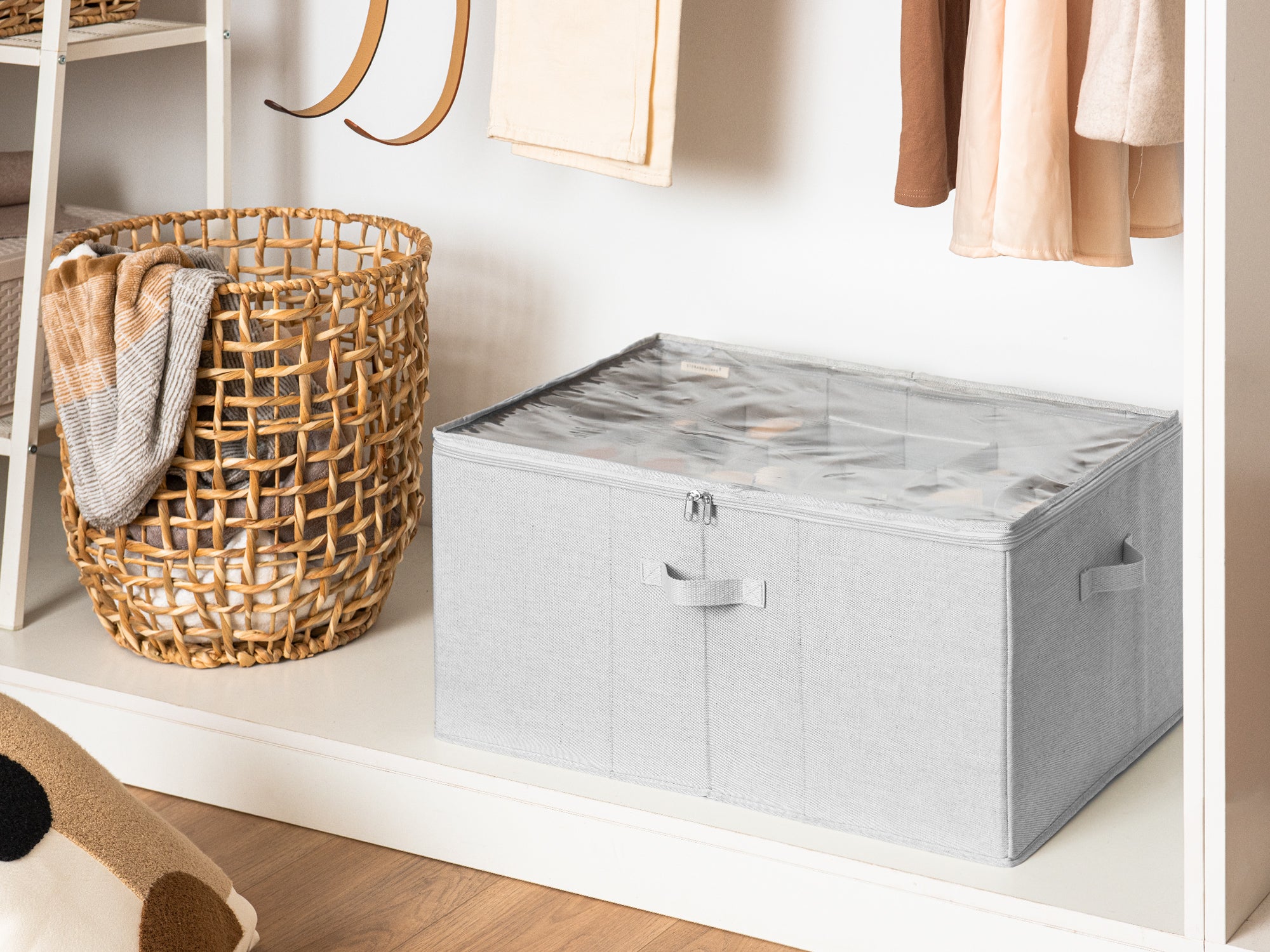 Large gray shoe storage organizer placed at the bottom of a closet beside a wicker basket