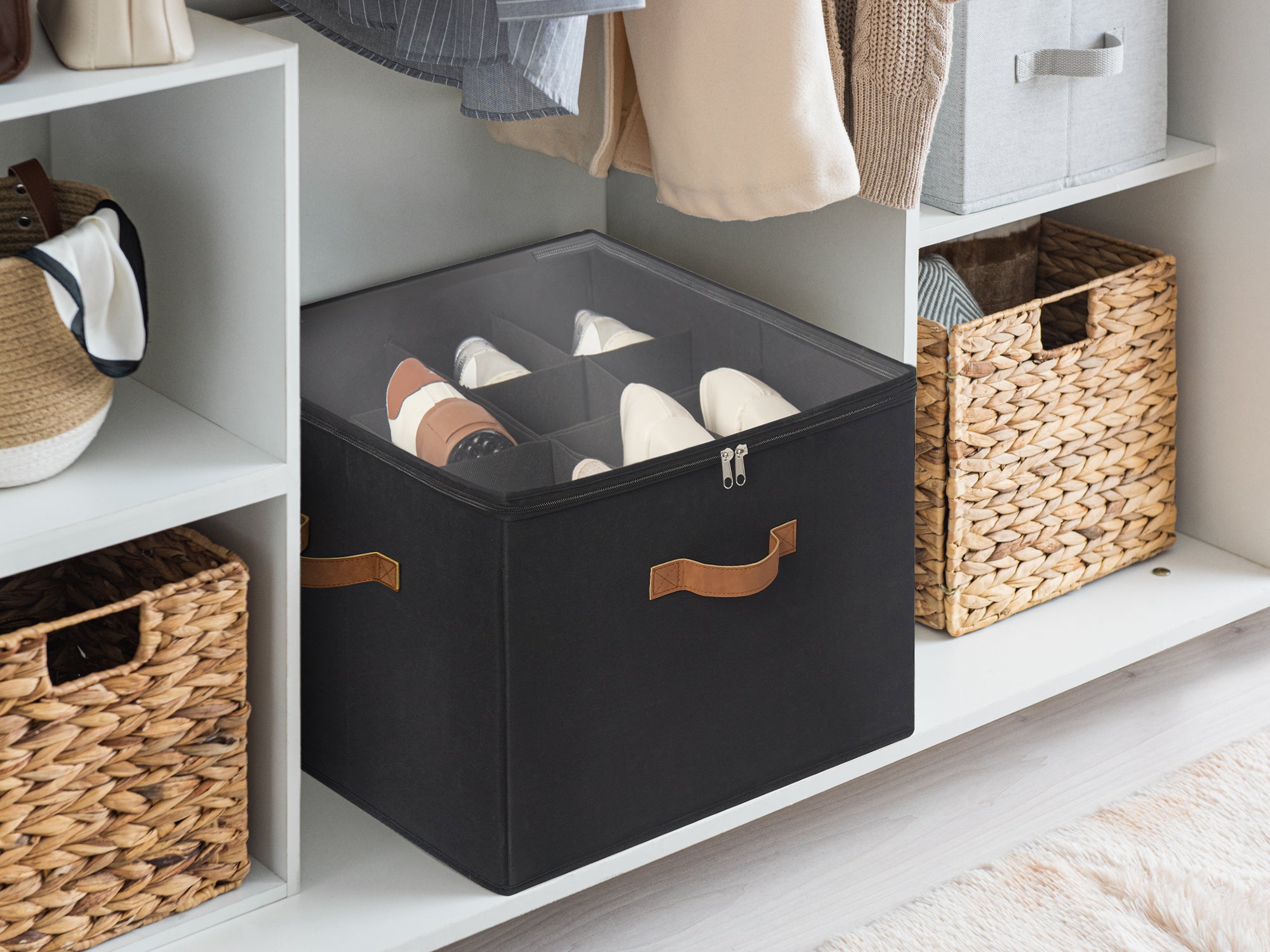 Black shoe organizer with brow PU handles featuring customizable pop-out dividers placed at the bottom of a closet