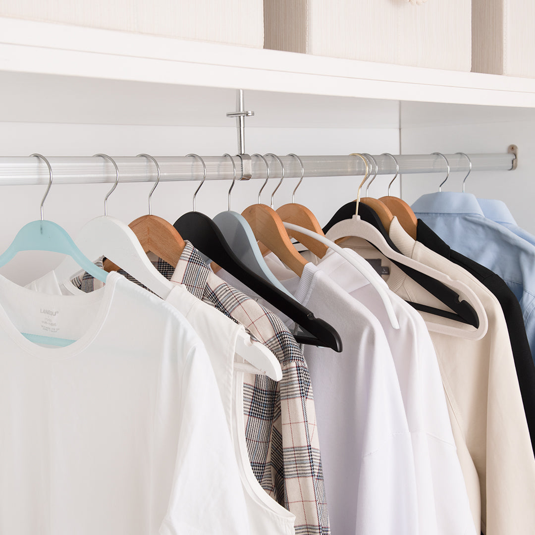 Colorful Wooden Cloth Hangers On Clothes Rail In White Wardrobe