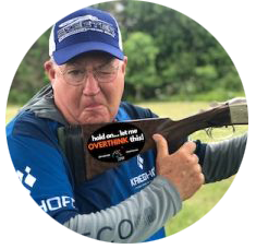 Gil Ash, director of OSP Shooting School, is winking and giving a thumbs-up for shooting sports.