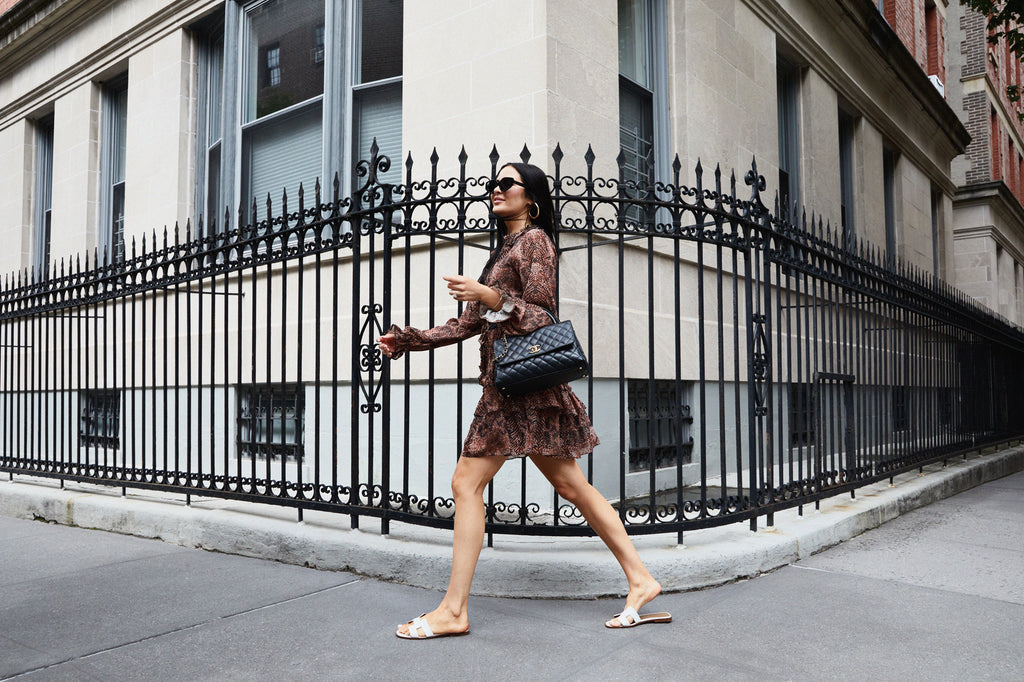 Rachel Parcell walking outside in New York City wearing Snake Print Ruffle Tiered Mini Dress