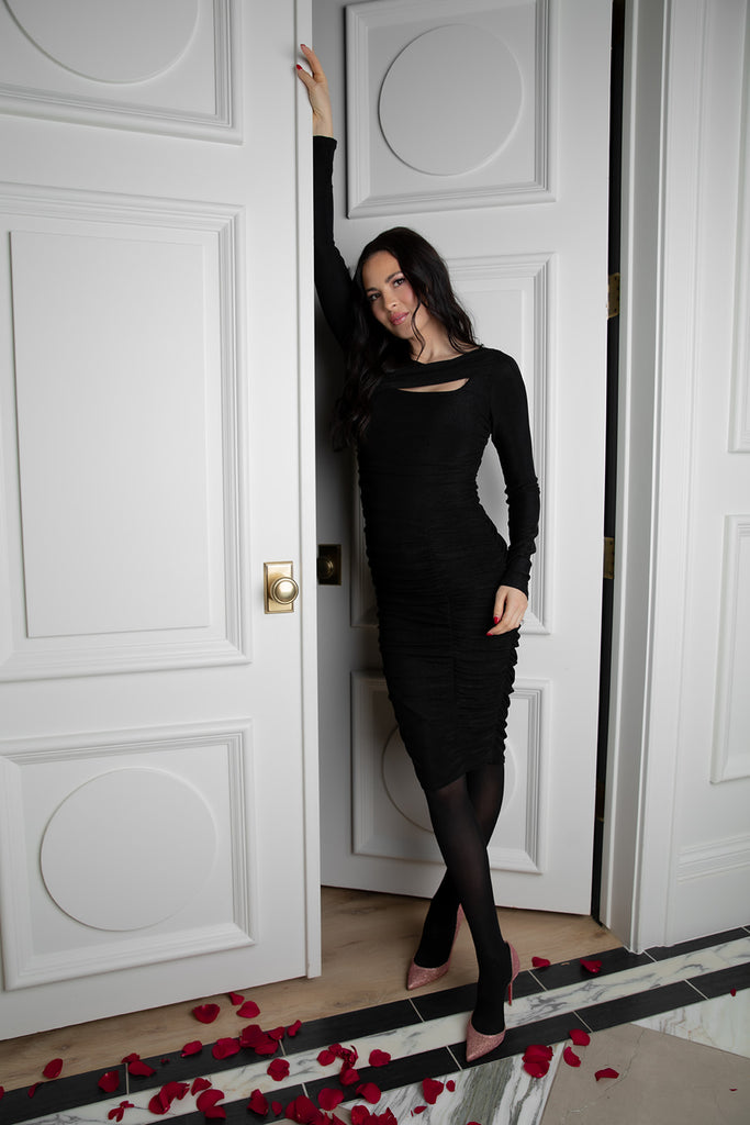 Rachel Parcell leaning against doorway inside her home wearing Black Diamond Ruched Cutout Dress