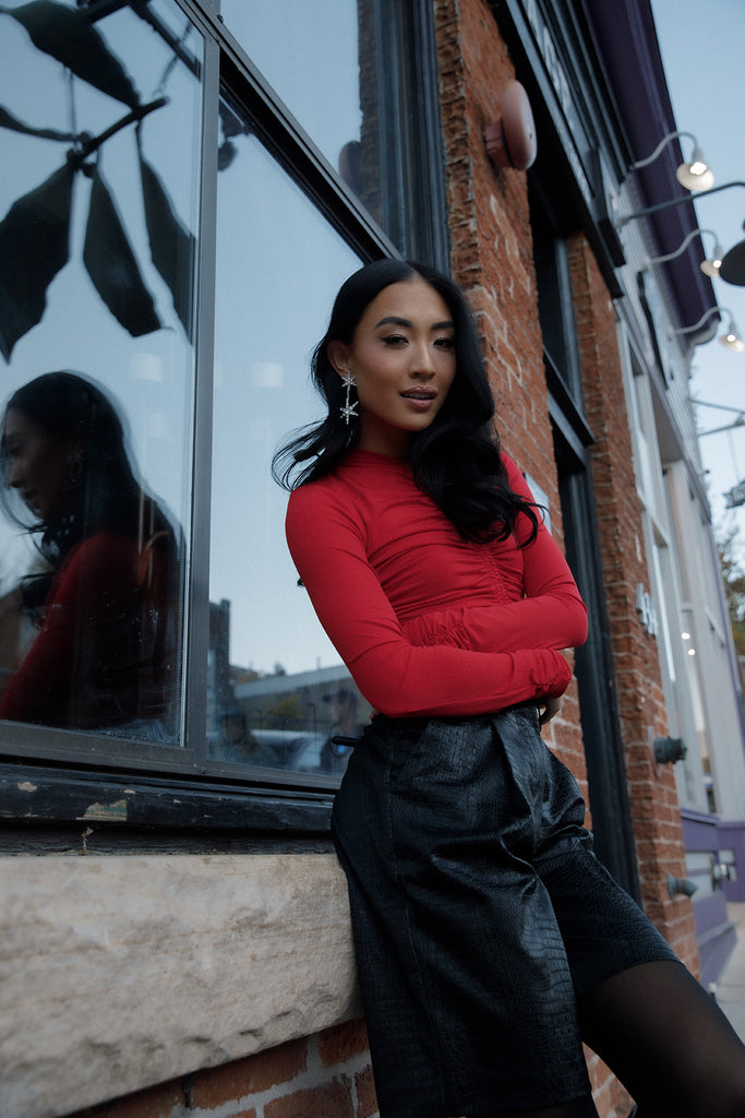 Model outside Main Street Park City wearing Ruby Lightweight Ruched Top and black leather shorts