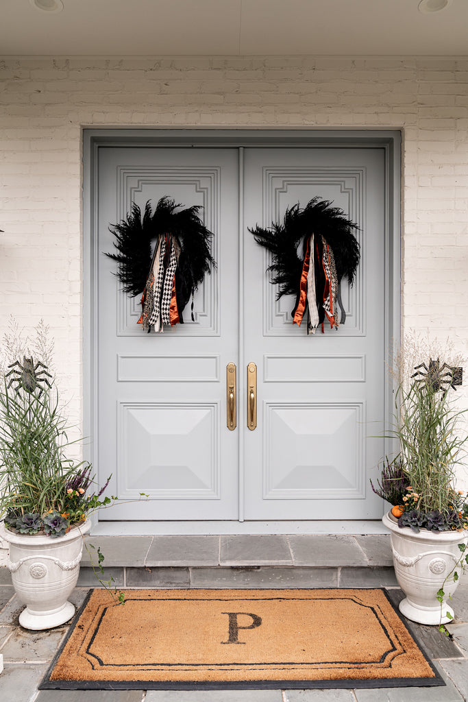 Close up image of Rachel Parcell's front doors with black feather wreaths