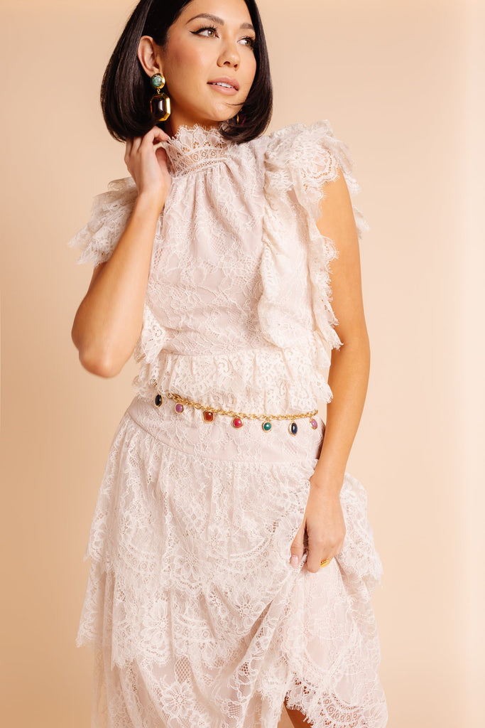 Model Sabrina wearing new white lace RP dress, Lele Sadoughi earrings and jeweled belt 