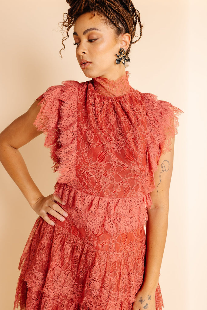 Model, Camille wearing new rust lace RP dress and brown floral Lele Sadoughi earrings 