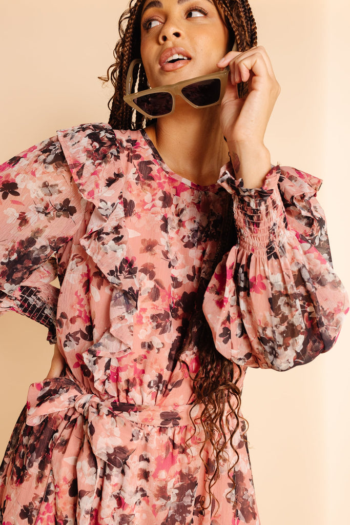 Close up of Model, Camille wearing RP Pink Floral Ink Smocked Long Sleeve Dress