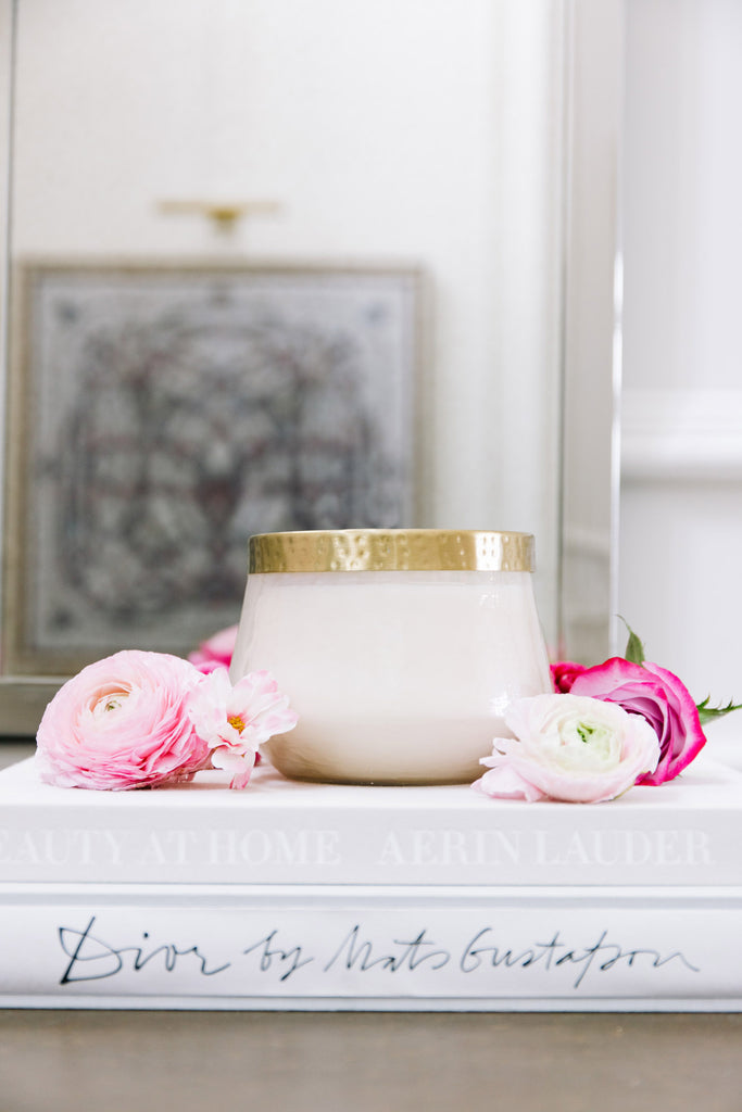 RP x Rosy Rings Large Pressed Botanical Floral Candle on fashion coffee table books surrounded by pink flowers