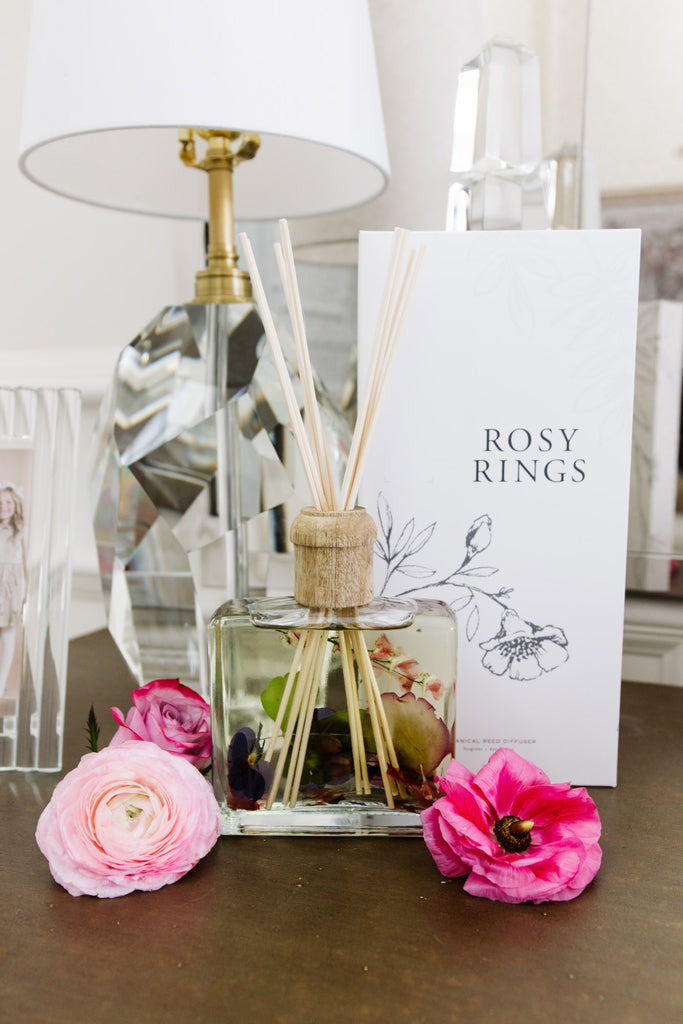 RP x Rosy Rings Botanical Diffuser on entry table with pink flowers around it 