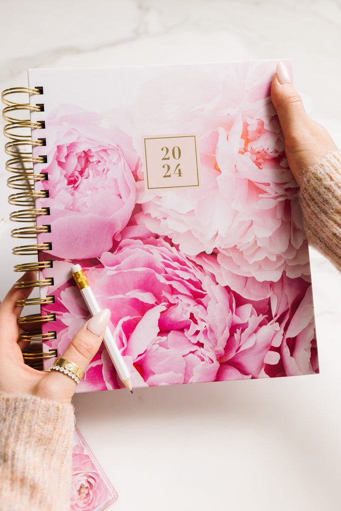 Close up of Rachel Parcell's hands holding Blue Sky 2024 Planner