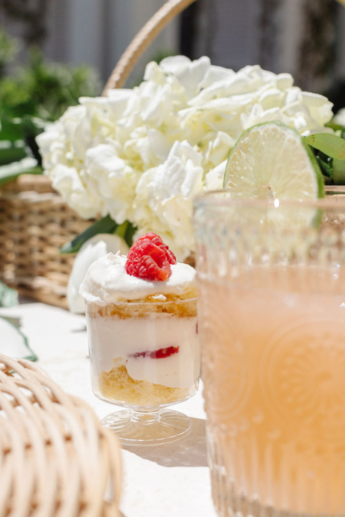 Mini lemon poundcake berry trifle dessert cup on table outside