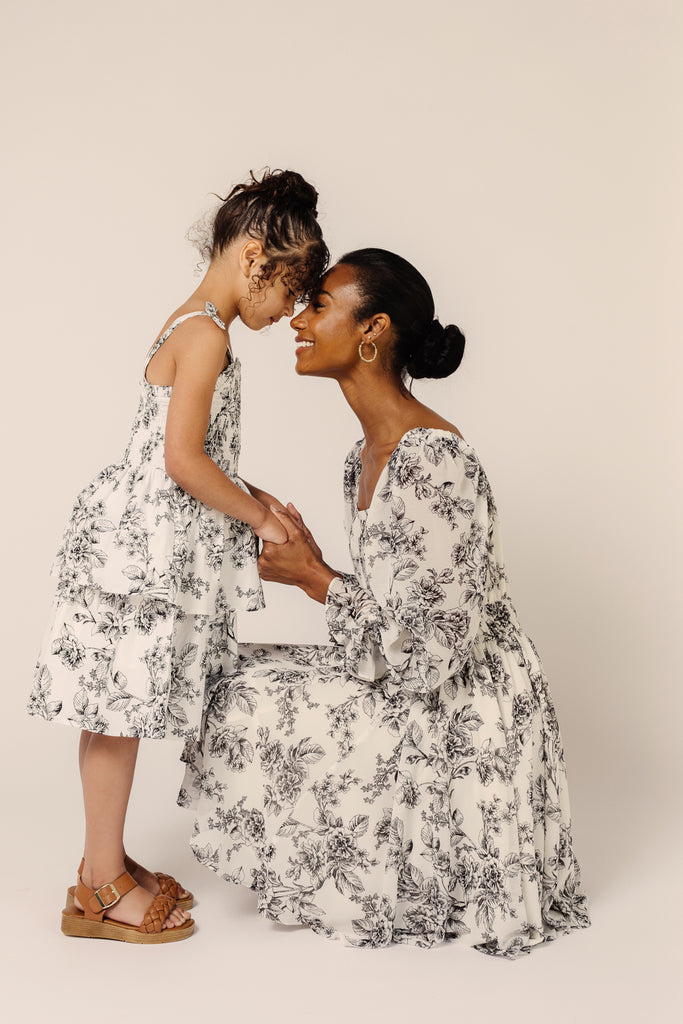 Mommy & Mini models Kayt and Tay wearing Black Toile Long Sleeve Chiffon Fit and Flare Dress and Black Toile Girls Dress