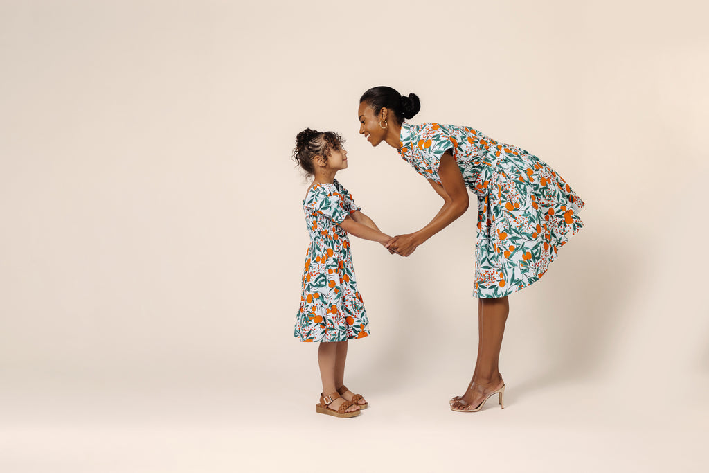 Mommy & Mini Models Kayt and Tay in Orange Blossom Sky Printed Cotton Shirt Dress and Girls Orange Blossom Puff Sleeve Dress
