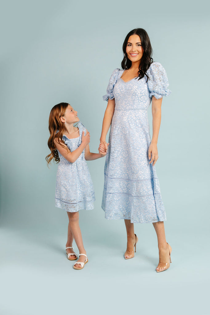 Rachel Parcell's daughter, Isla Rose Parcell in RP Celestine Blue Flared Lace dress holding hands with Rachel Parcell wearing Celestine Blue Flared Lace Midi Dress