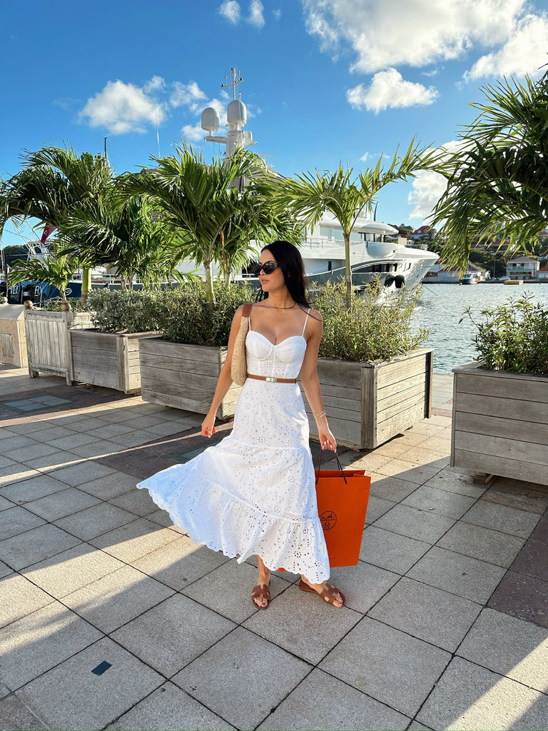 Rachel Parcell outside shopping in St. Barths wearing white eyelet midi dress