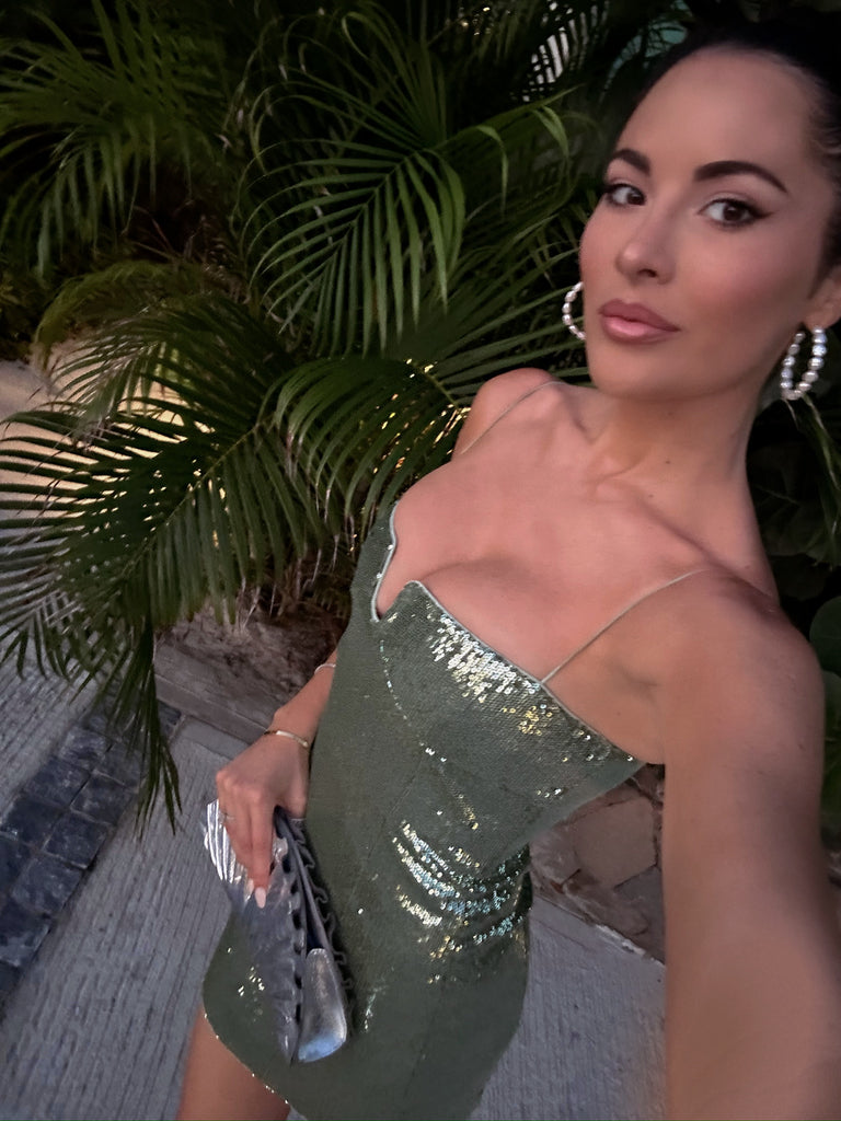 Selfie of Rachel Parcell at night in St. Barths wearing green sequin mini dress