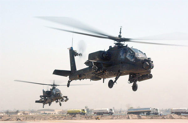 Two U.S. Army Apache helicopters take off from Camp Victory, Baghdad Province, Iraq in 2008.