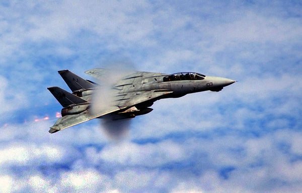  This US Navy F-14D Tomcat performs a high-speed fly-by causing the moisture in the air around the aircraft to condense into vapor as the aircraft breaks the sound barrier.