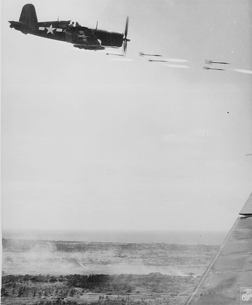 A Corsair fighter shoots rockets at a Japanese stronghold in Okinawa, Japan ca. June 1945