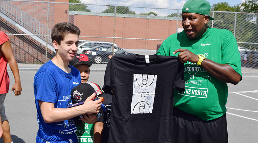 Will Strickland presenting Julius McGee with an Art Pays Me t-shirt