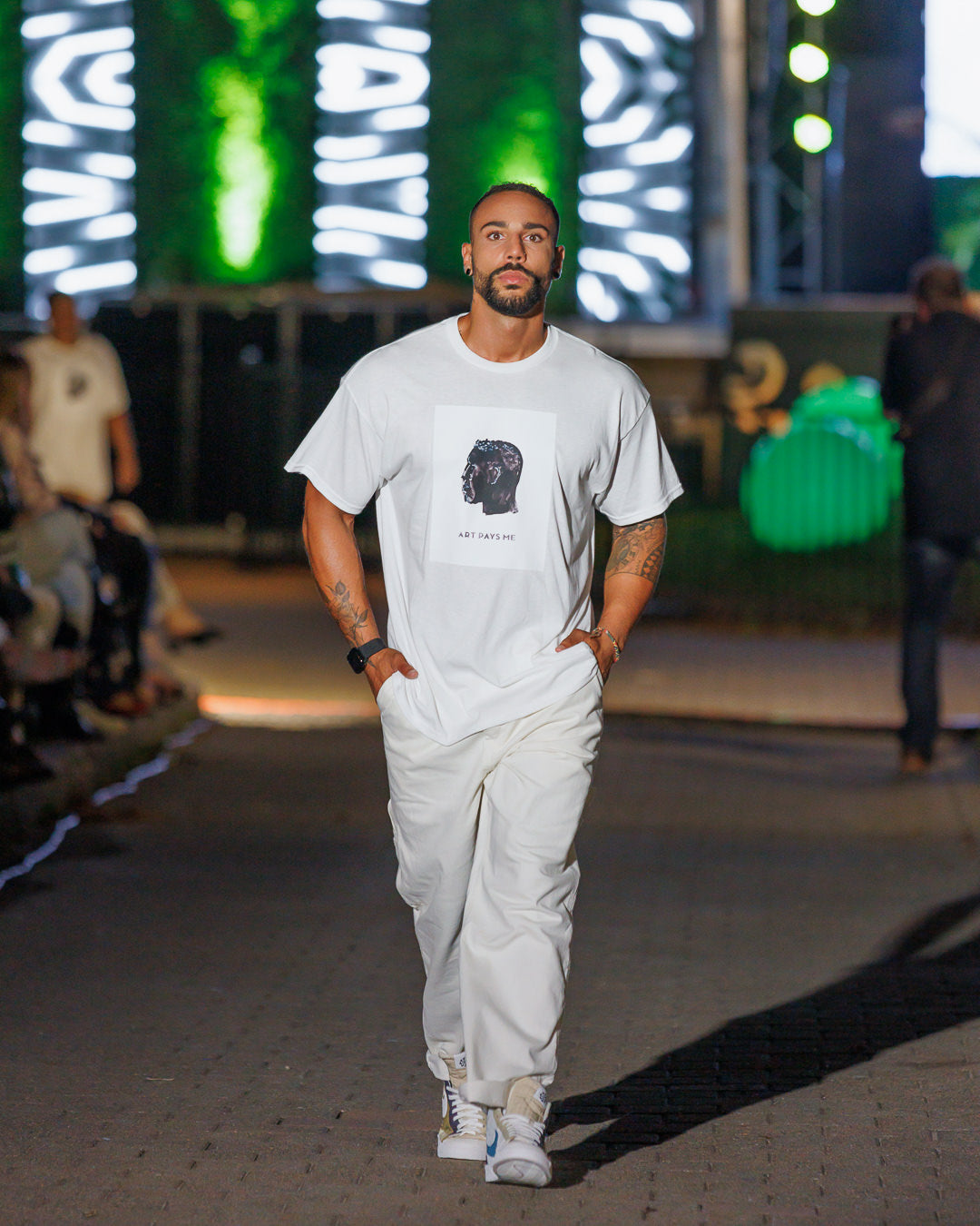 Man wearing a white t-shirt with a side profile head on the front