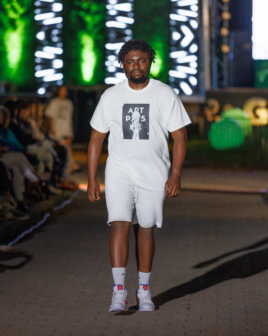 Man wearing a white t-shirt with a fighter drawing on the front