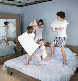 Kids playing on bed