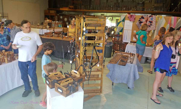 More shoppers looking at wood turnings.