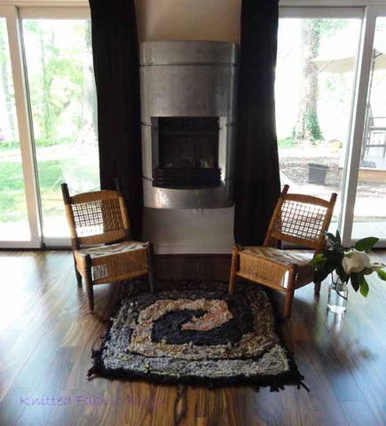 Brown and gray square spiral in front of the fireplace.
