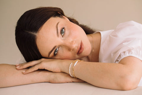 woman wearing pearl bracelets