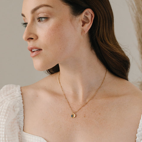 woman wearing birthstone necklace