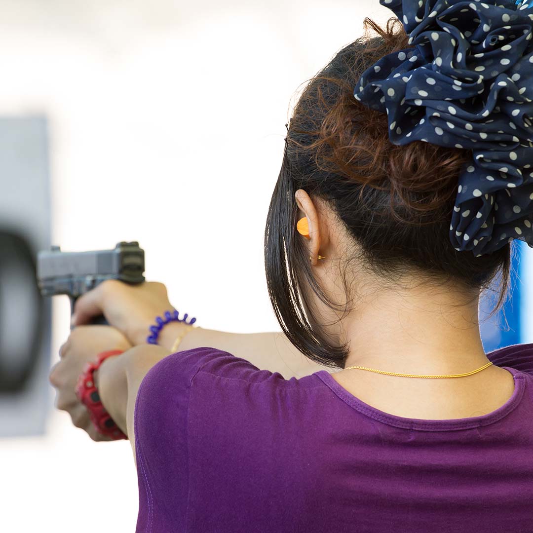 A young female holding a gun.