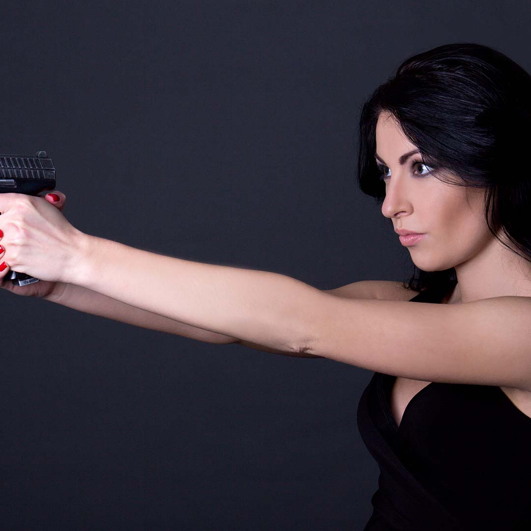 A young female holding a gun.